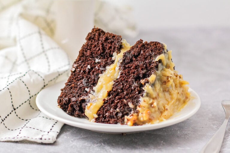 A slice of German chocolate cake on a white plate.