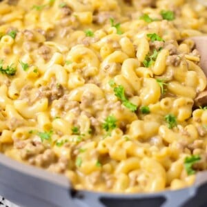 A pan of hamburger helper with a wooden spoon.