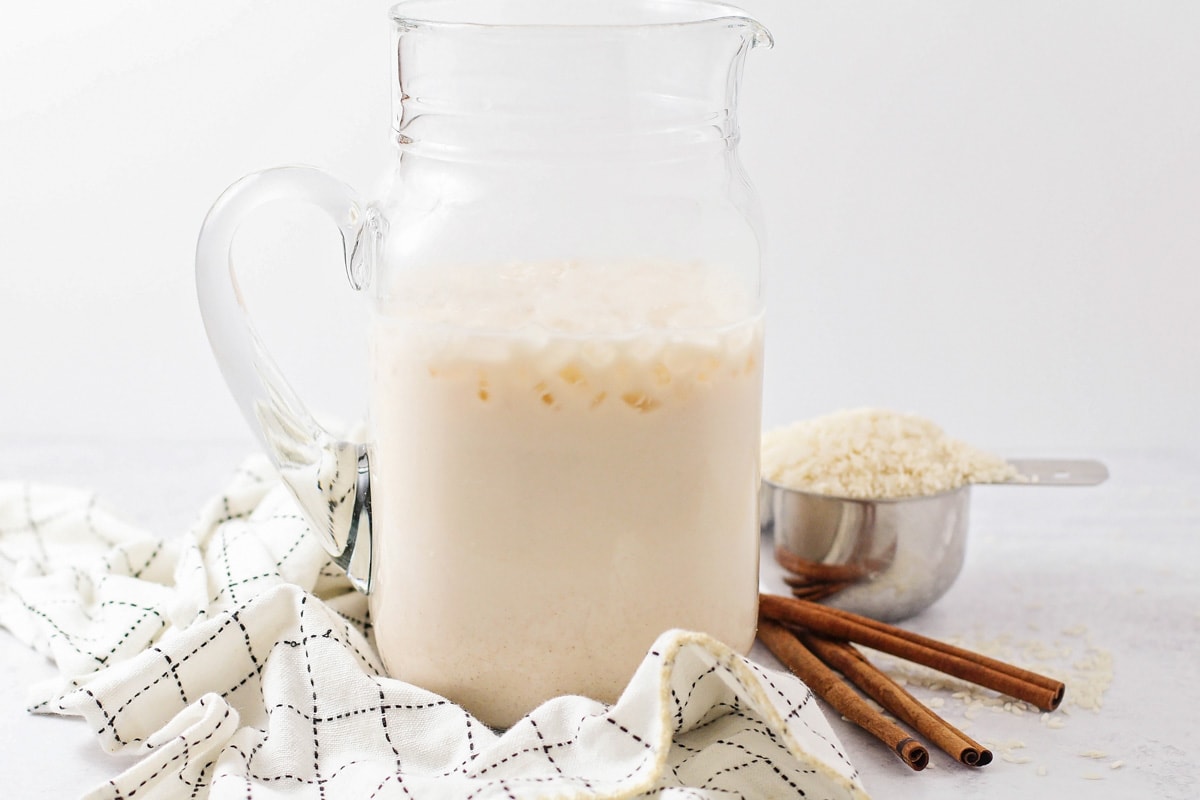 Chilled horchata served in a glass pitcher.