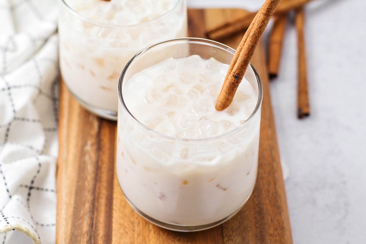 Horchata served chilled with ice and a cinnamon stick.