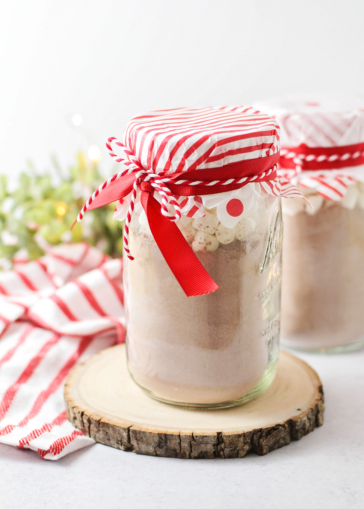 Close up of filled and decorated mason jar hot chocolate gifts.