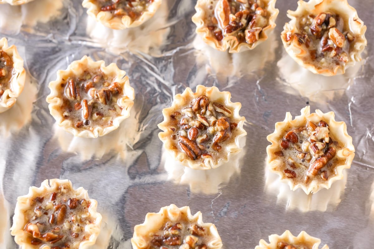 Mini pecan pies filled and ready to bake.