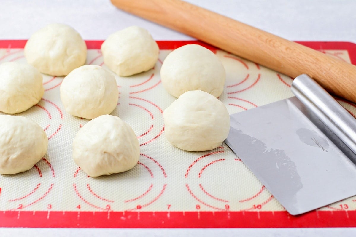 Naan bread dough pieces on Silpat.