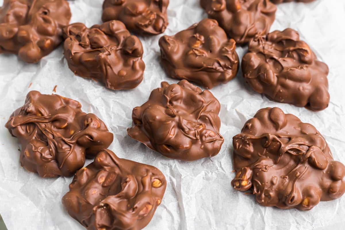 Peanut clusters cooling on wax paper.
