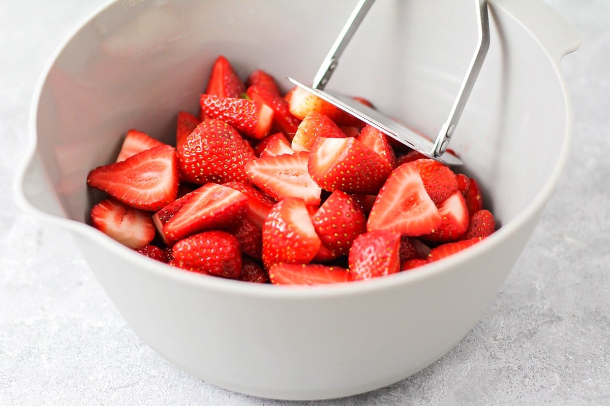 Prepping strawberries for strawberry jam.