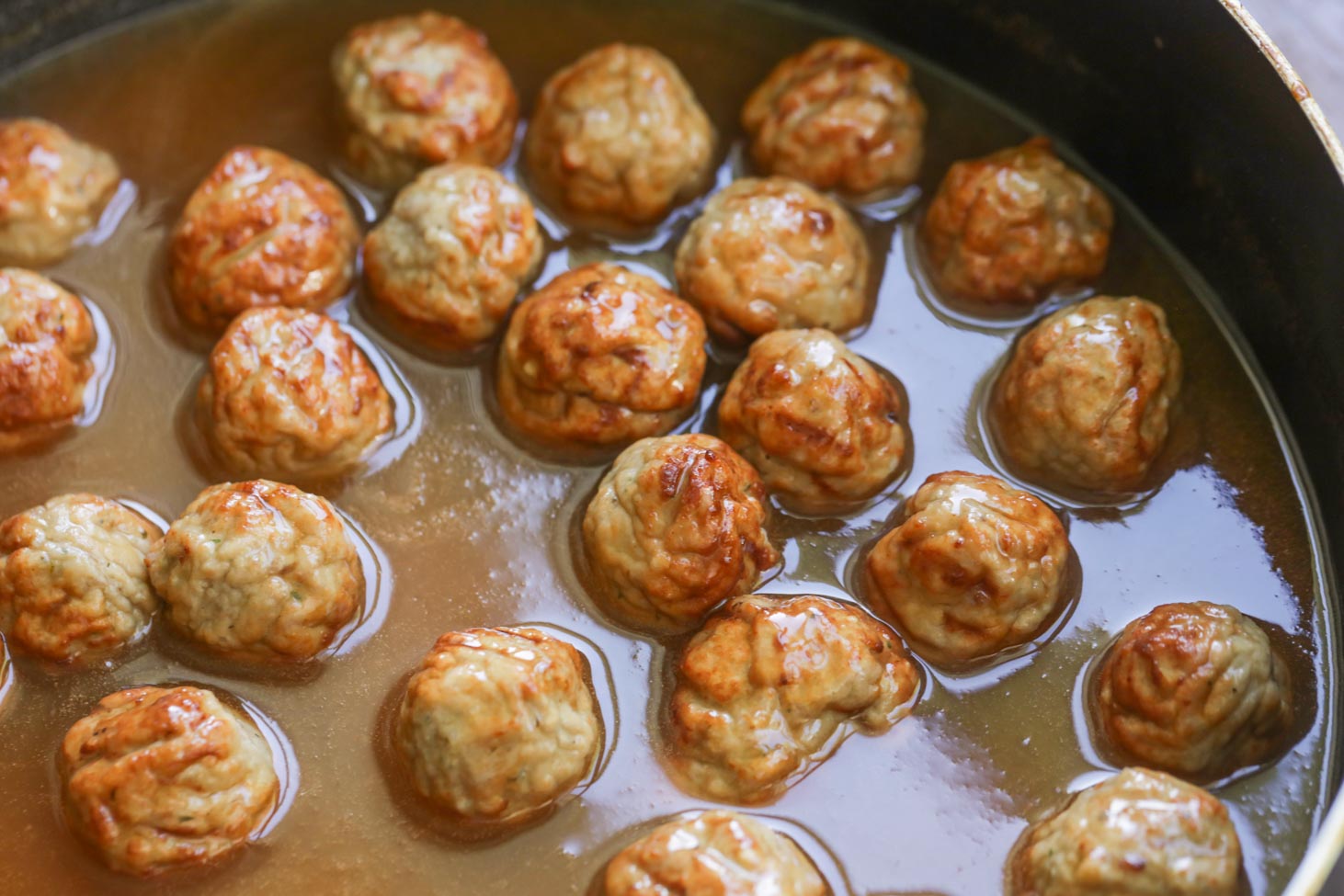 Cooking meatballs for sweet and sour meatballs.