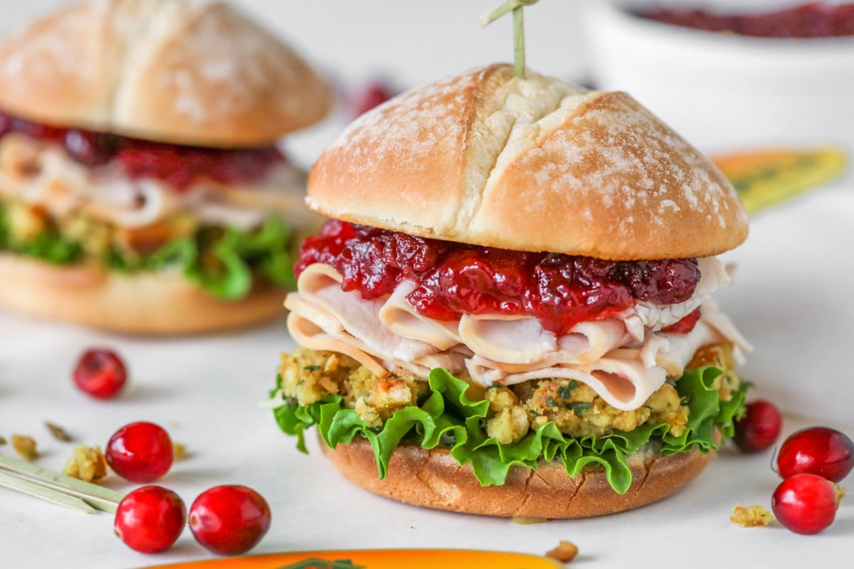 Turkey Cranberry Sandwich close up image with stuffing, lettuce, turkey and cranberries.