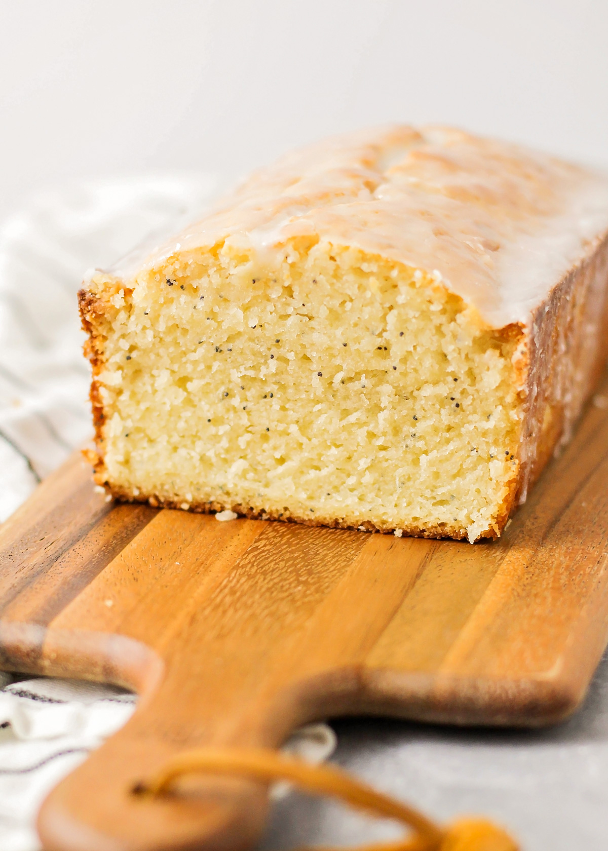 Almond Poppy Seed Bread loaf topped with glaze.