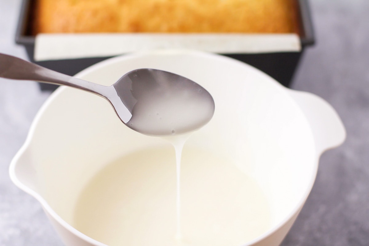 Mixing ingredients for glaze in a white mixing bowl.