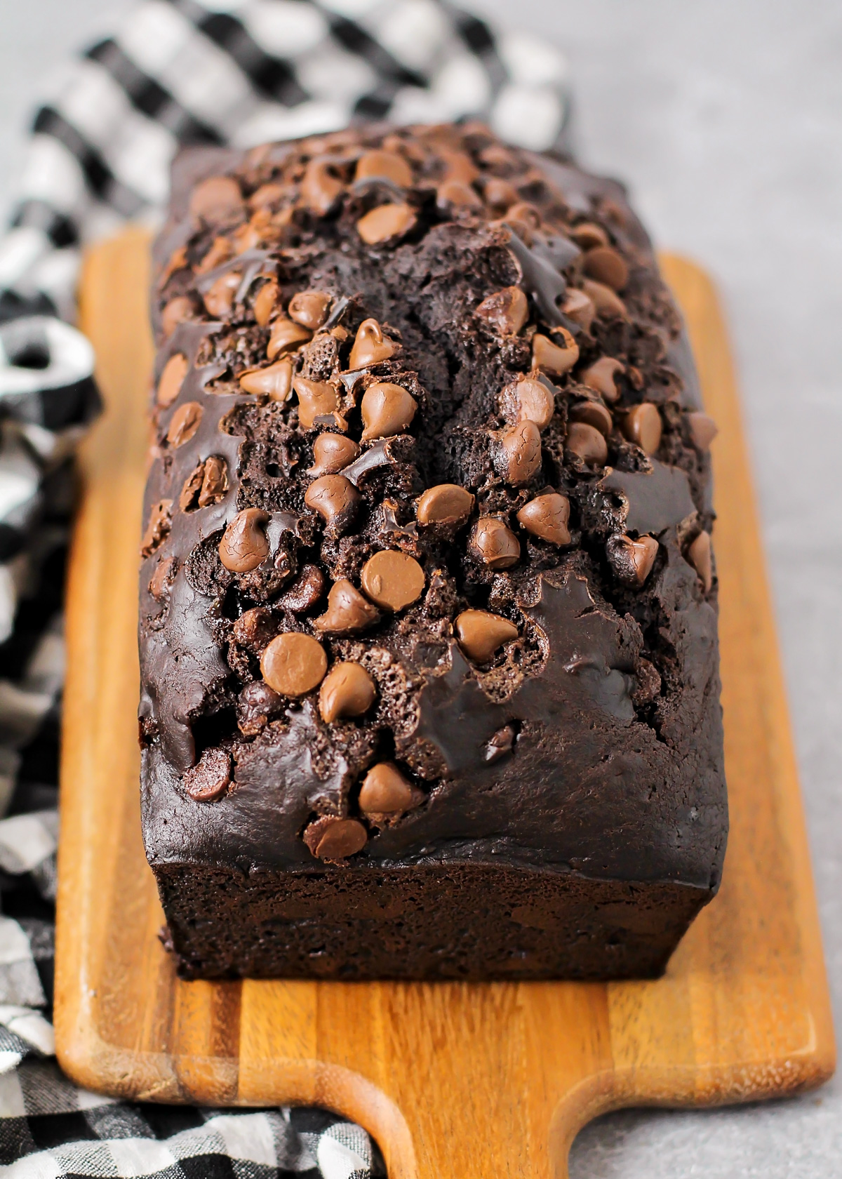 A loaf of chocolate bread on a cutting board.
