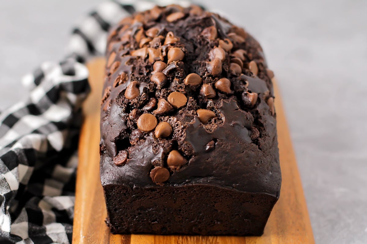 A loaf of chocolate bread topped with chocolate chips. 