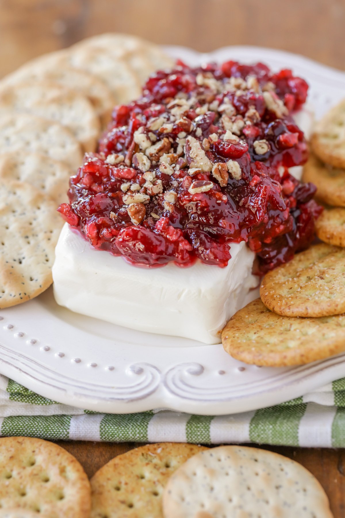 Close up of cranberry cream cheese dip served with crackers.