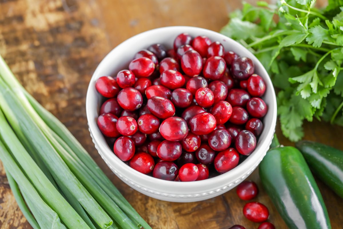 A bowl full of cranberries to use in cranberry salsa recipe.