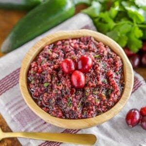 Fresh cranberry salsa served in a wooden bowl.