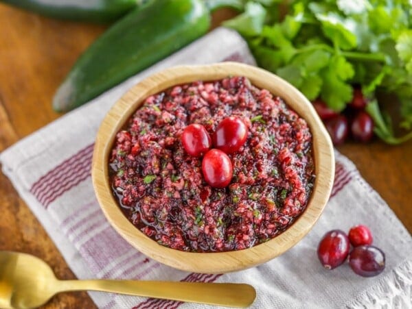 Fresh cranberry salsa served in a wooden bowl.