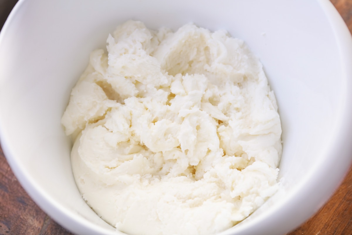 Cream cheese mints ingredients mixed together in a bowl.