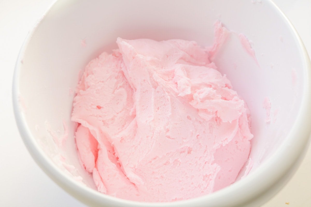 Light pink cream cheese mints ingredients in bowl.