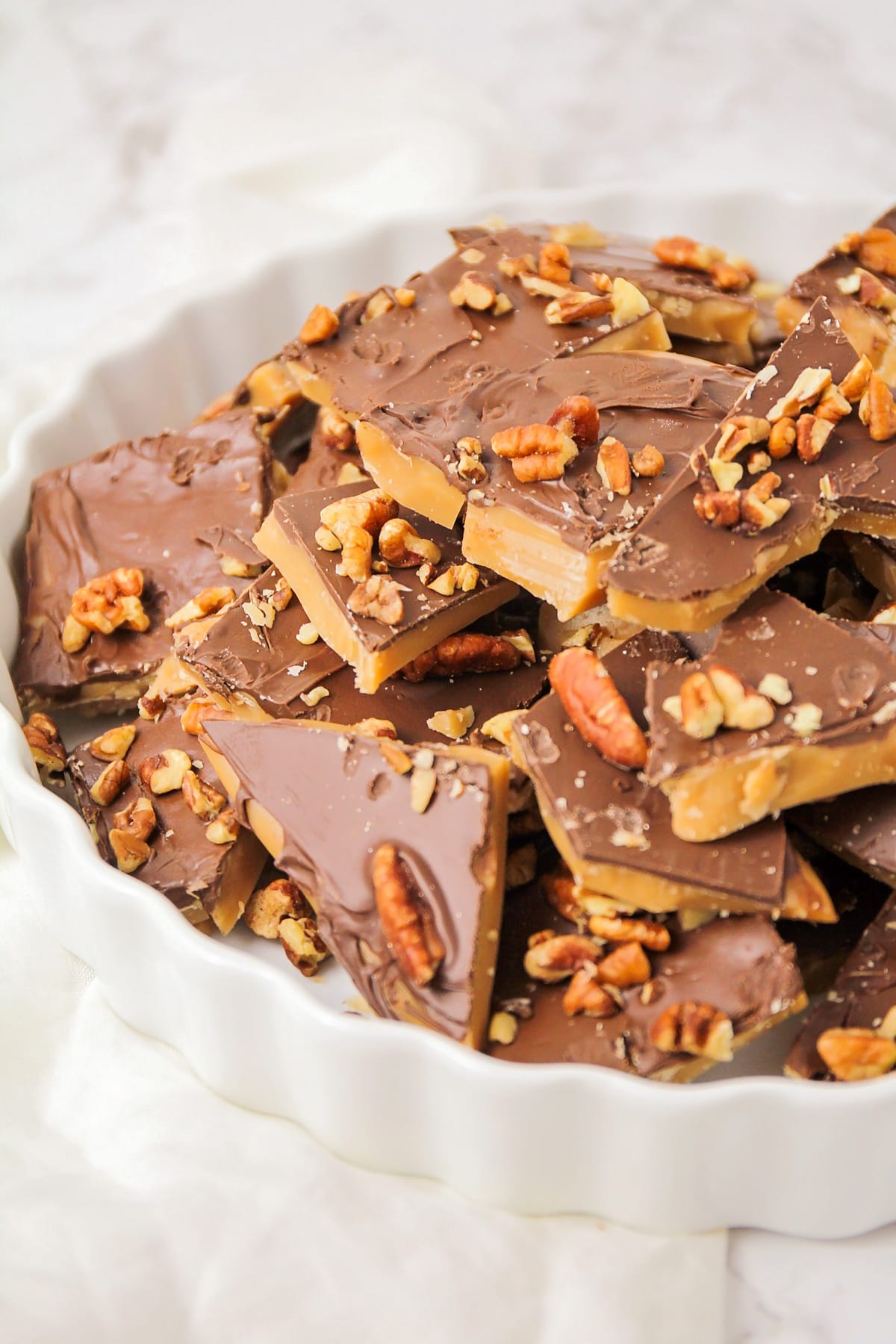 Homemade toffee recipe in pieces in dish.