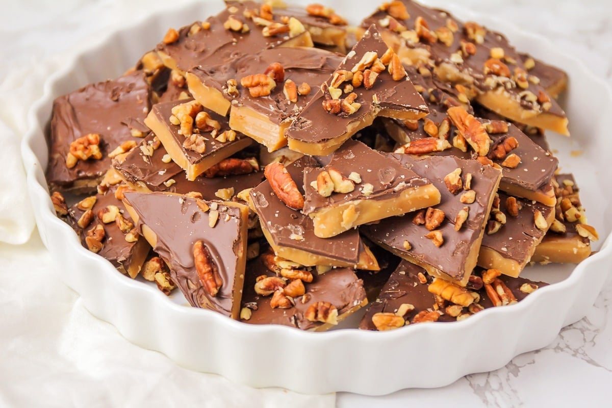 Homemade toffee recipe piled on a white plate.