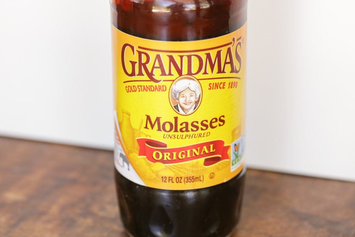 A jar of molasses on a kitchen table.