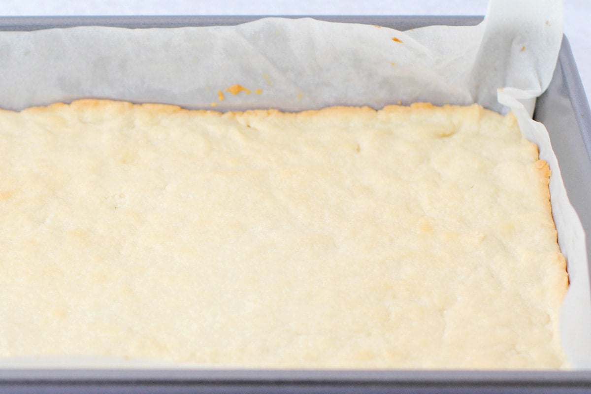 Baked crust in a pan lined with parchment paper.