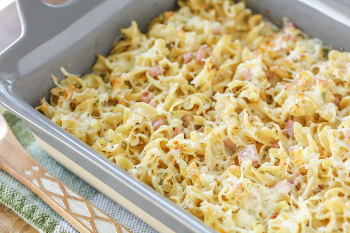 A cooked mac and cheese with ham casserole in a baking dish.