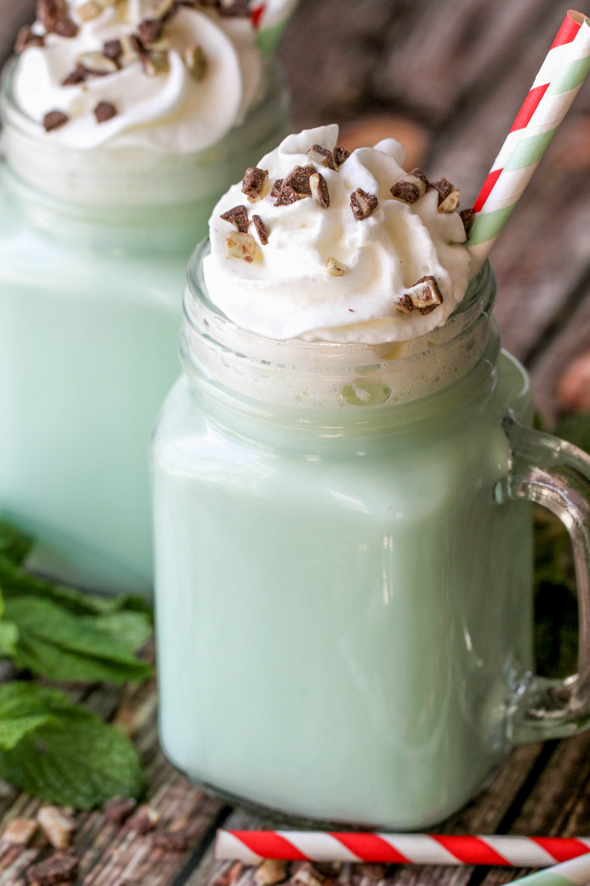 Two glass mugs filled with mint hot cocoa.
