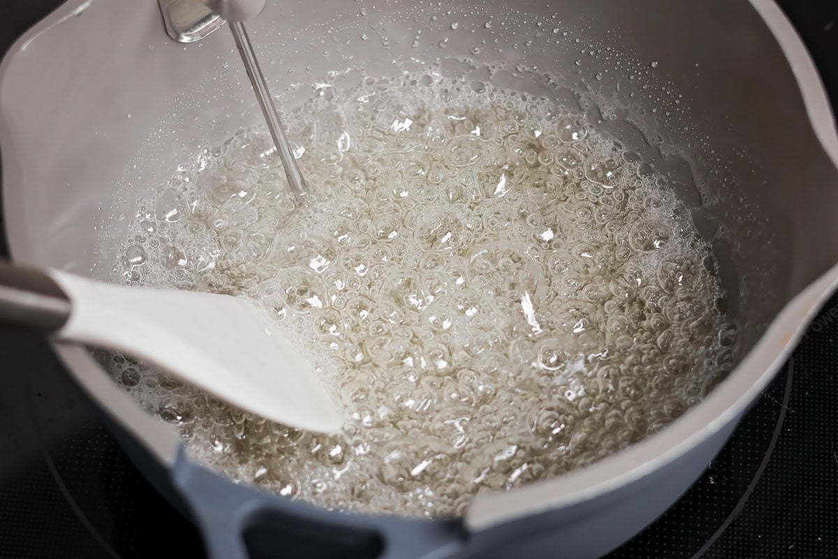 Sugar mixture boiling in pot.