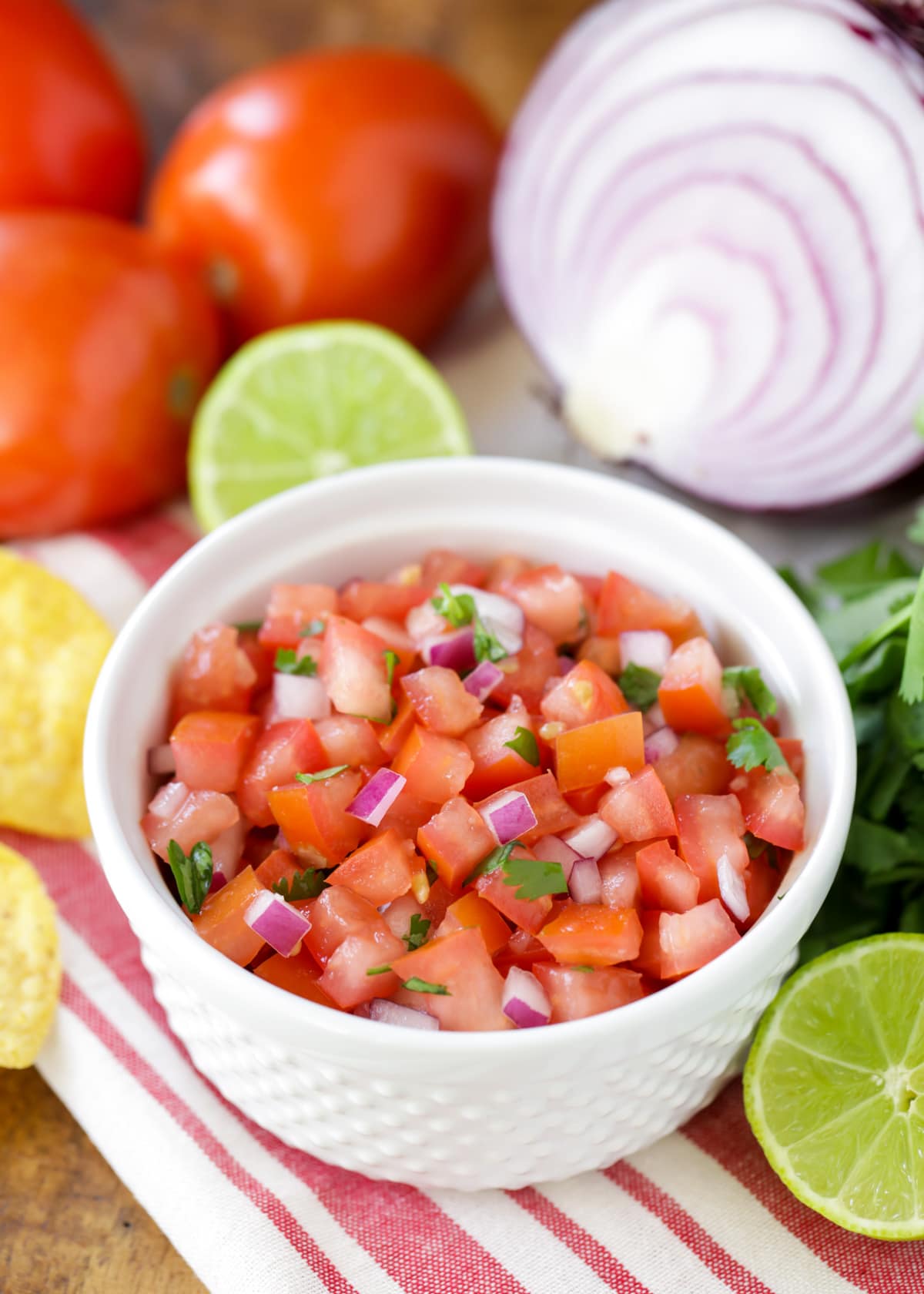 Close up of homemade pico de gallo in a small white bowl.