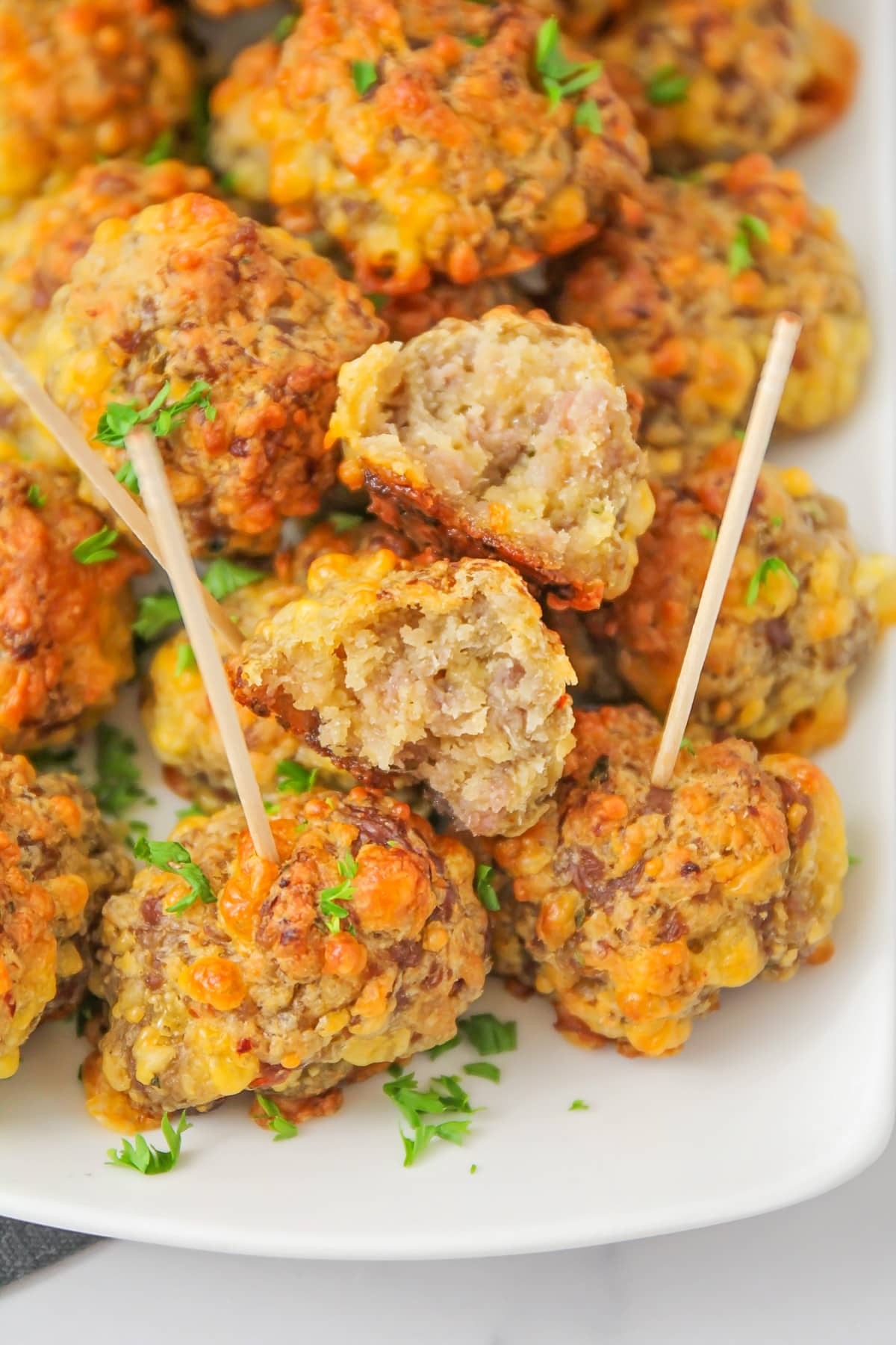 Close up of bisquick sausage cheese balls on toothpicks.