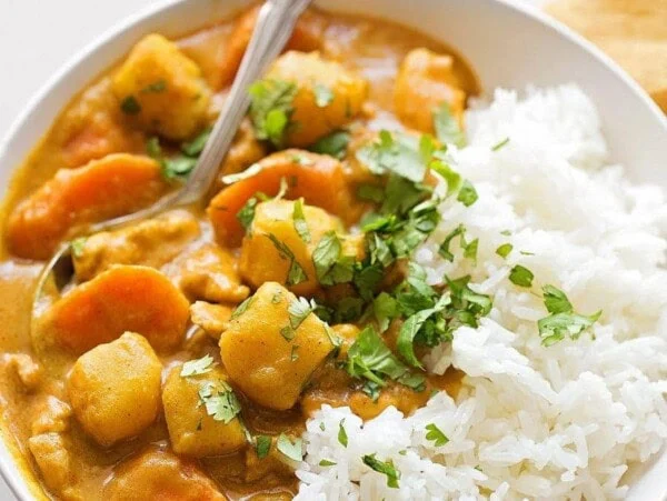 Coconut chicken curry recipe in white bowl.