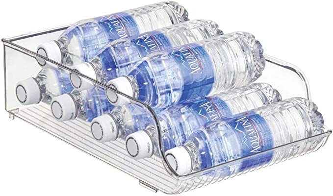 Kitchen organization ideas - An open, clear storage container holding several bottle of water.