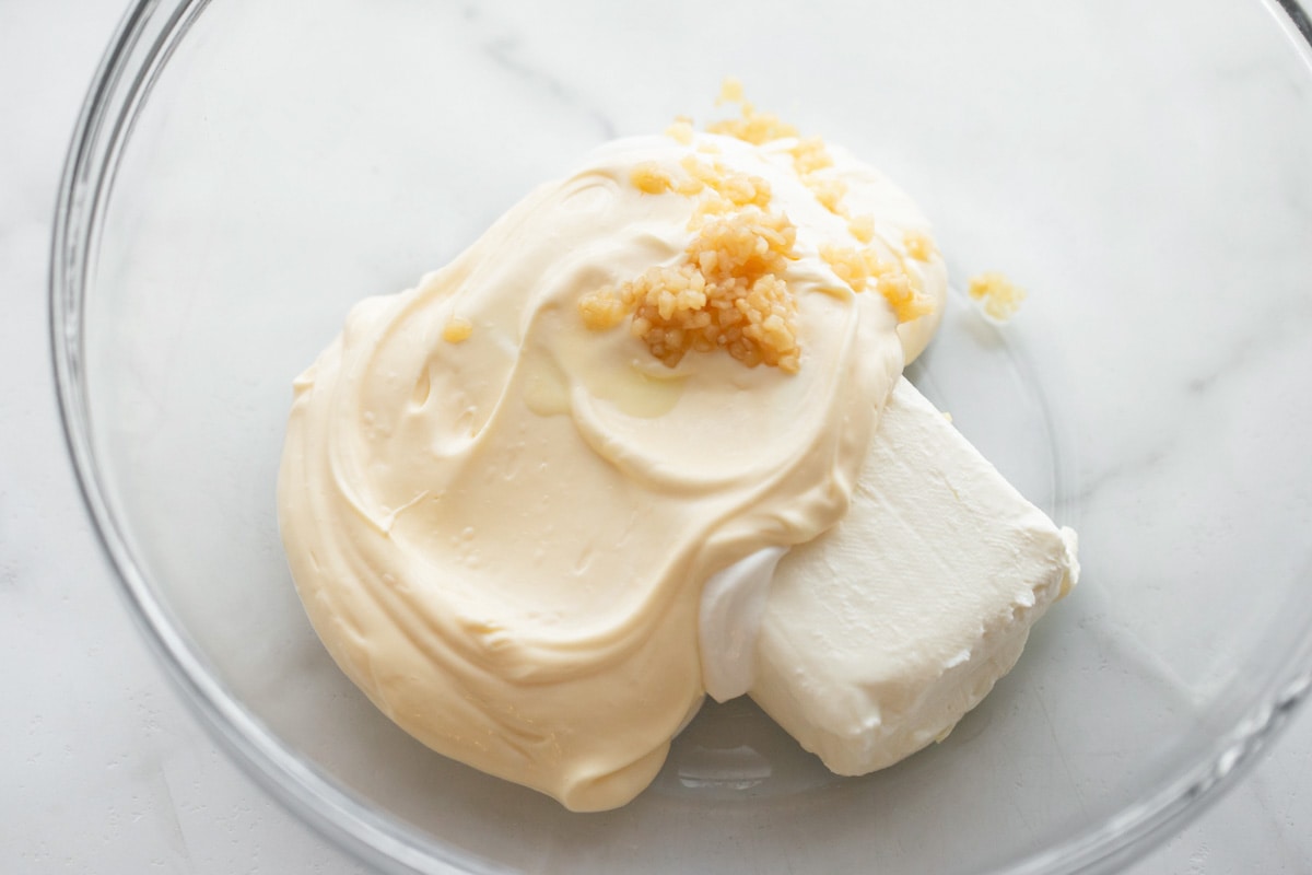 Cream mixture in bowl for artichoke dip.