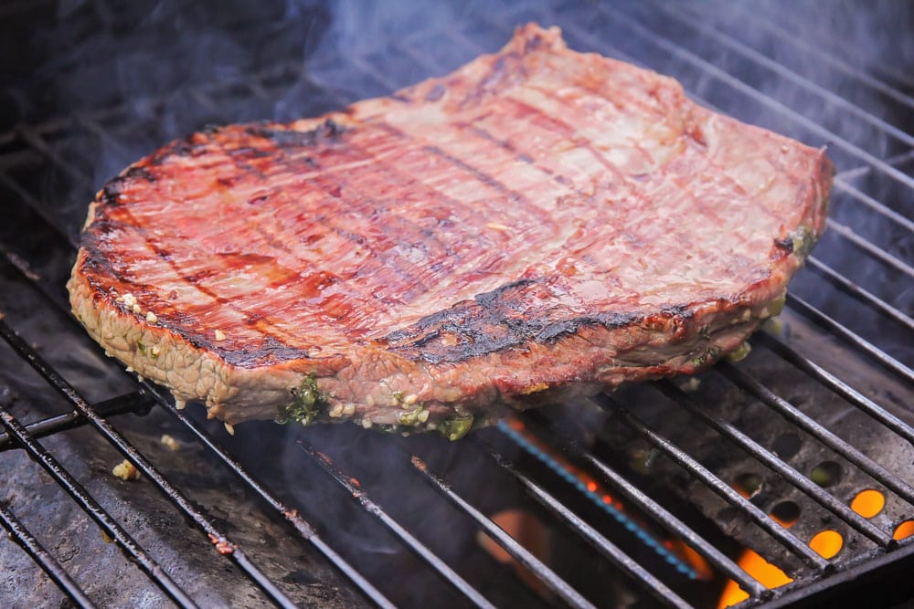 Carne asada meat being grilled.