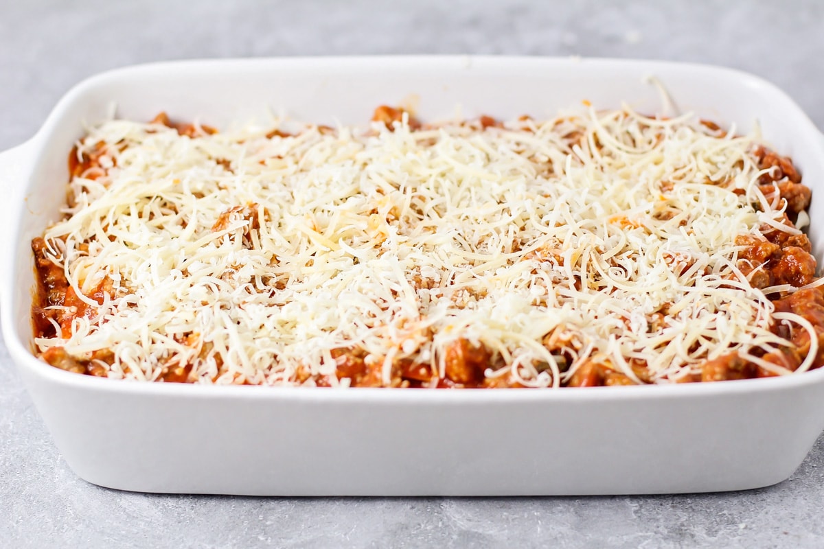 Easy lasagna recipe topped with cheese and ready to be baked.