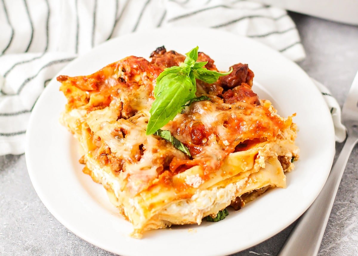 A serving of easy lasagna recipe on a white plate.