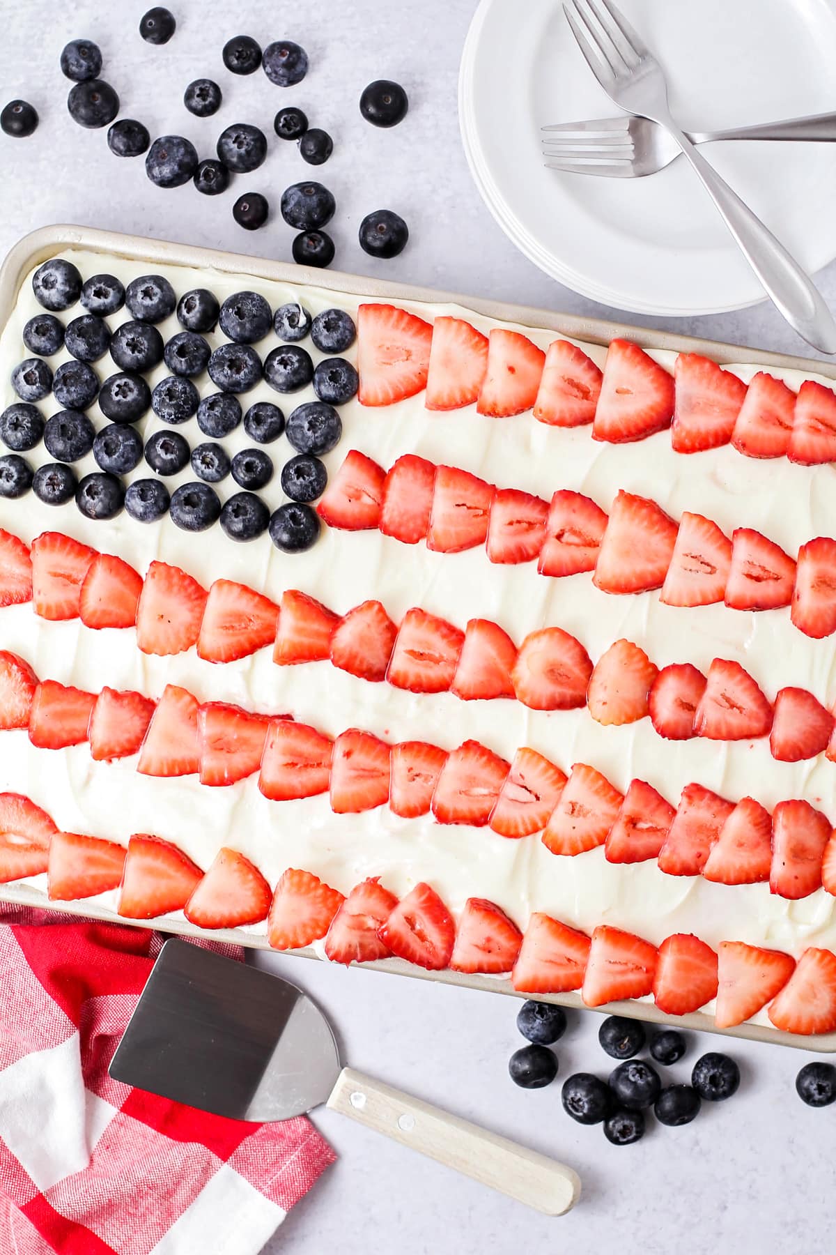 American Flag Cake decorated with blueberries and strawberries.