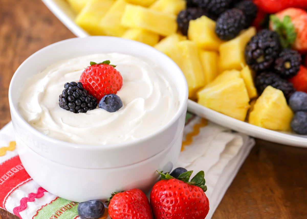 A bowl of fruit dip served with fresh fruit.