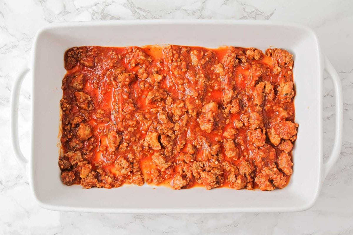The meat sauce layer in a baking dish for homemade lasagna.