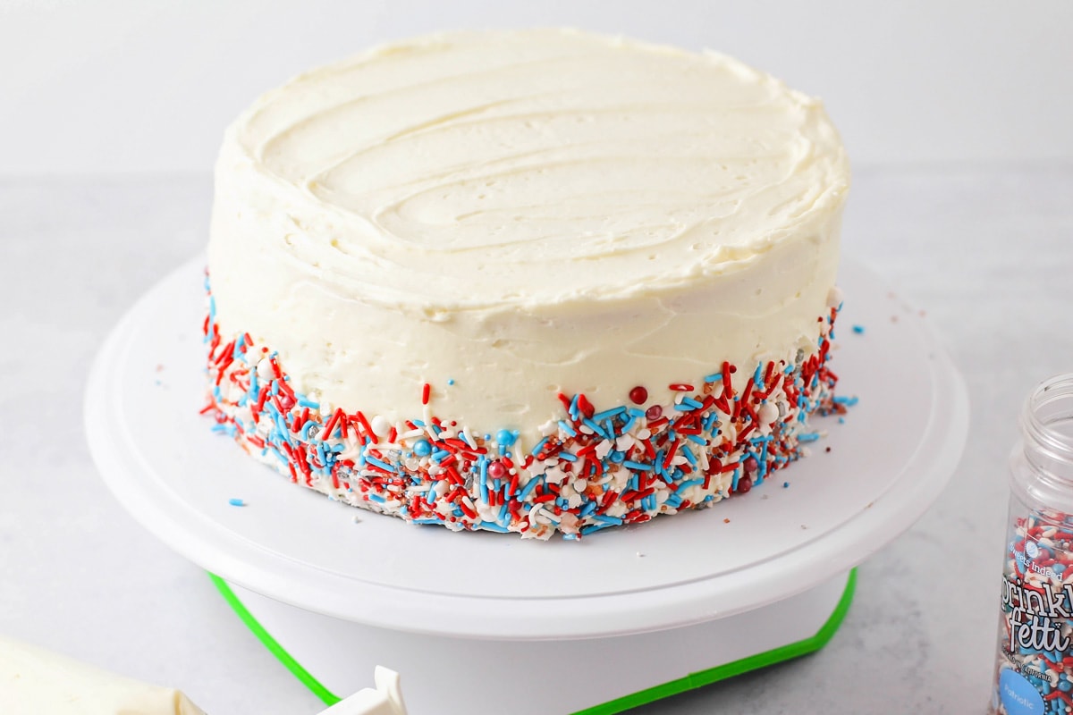 Frosting and decorating red white and blue cake.