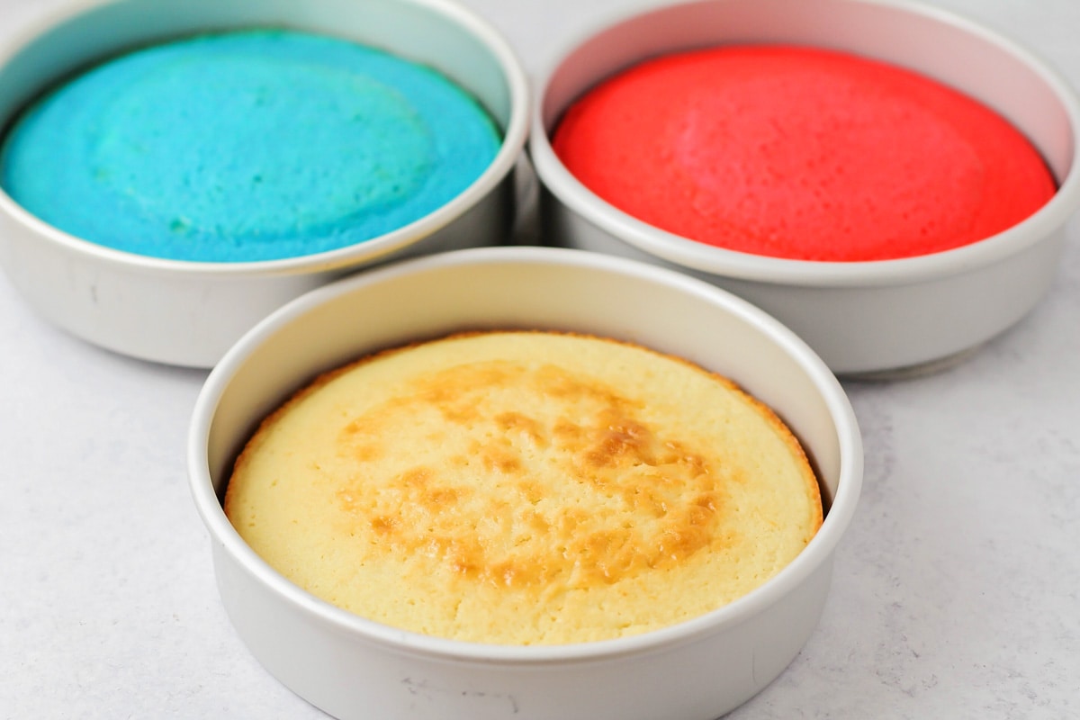 Baked red white and blue cake in three different cake pans.