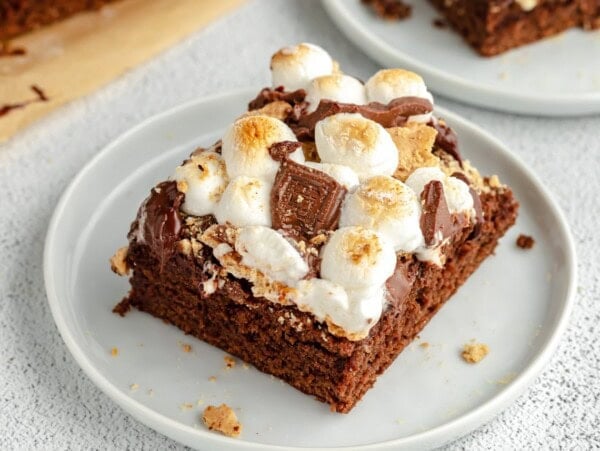 A slice of s'mores brownies on a white plate.