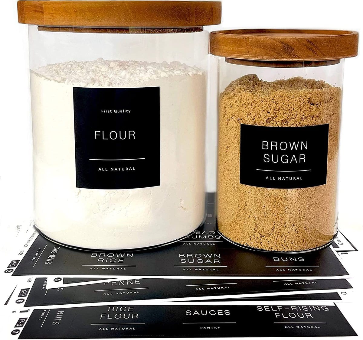 Pantry Organization Ideas - two clear glass jars with bamboo lids and black labels with white font attached that read "flour" and "brown sugar".