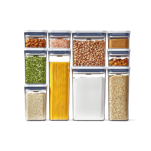 Pantry Organization Ideas - ten clear plastic food storage containers with white lids containing various dry foods.