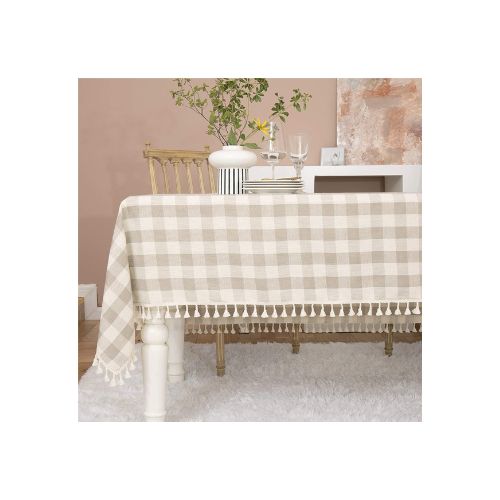 White and beige checkered tablecloth on a table.