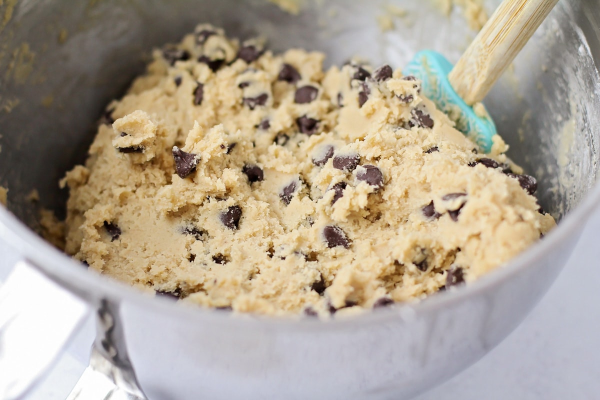 Cookie dough mixed in a metal bowl.