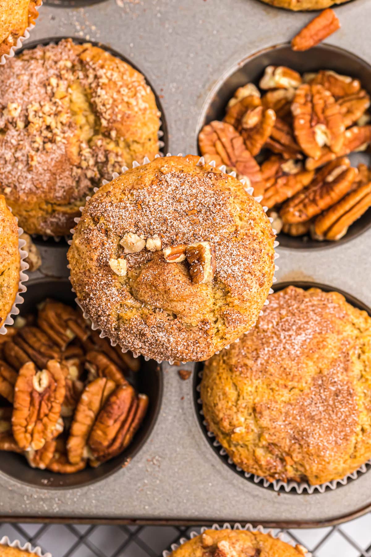 Close up of a banana nut muffin topped with pecans.