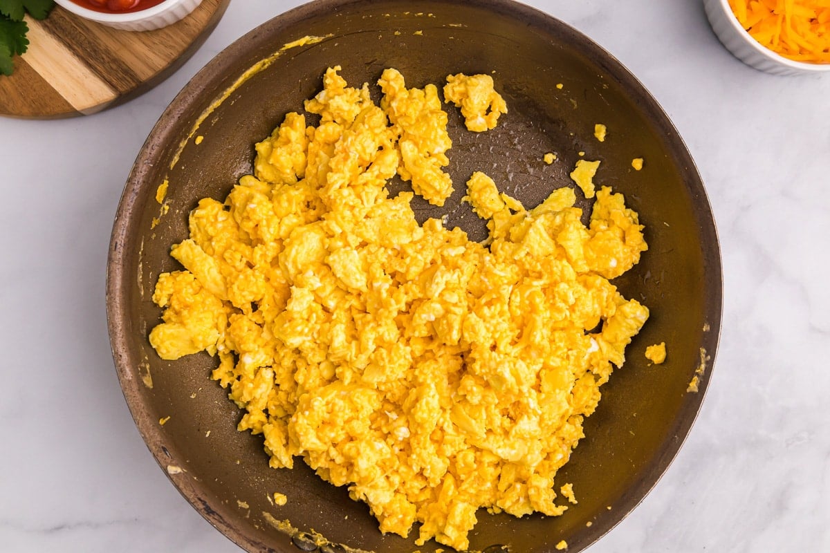 Scrambled eggs in a skillet.