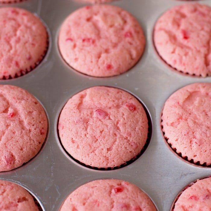 Cherry almond cupcakes in muffin tin.