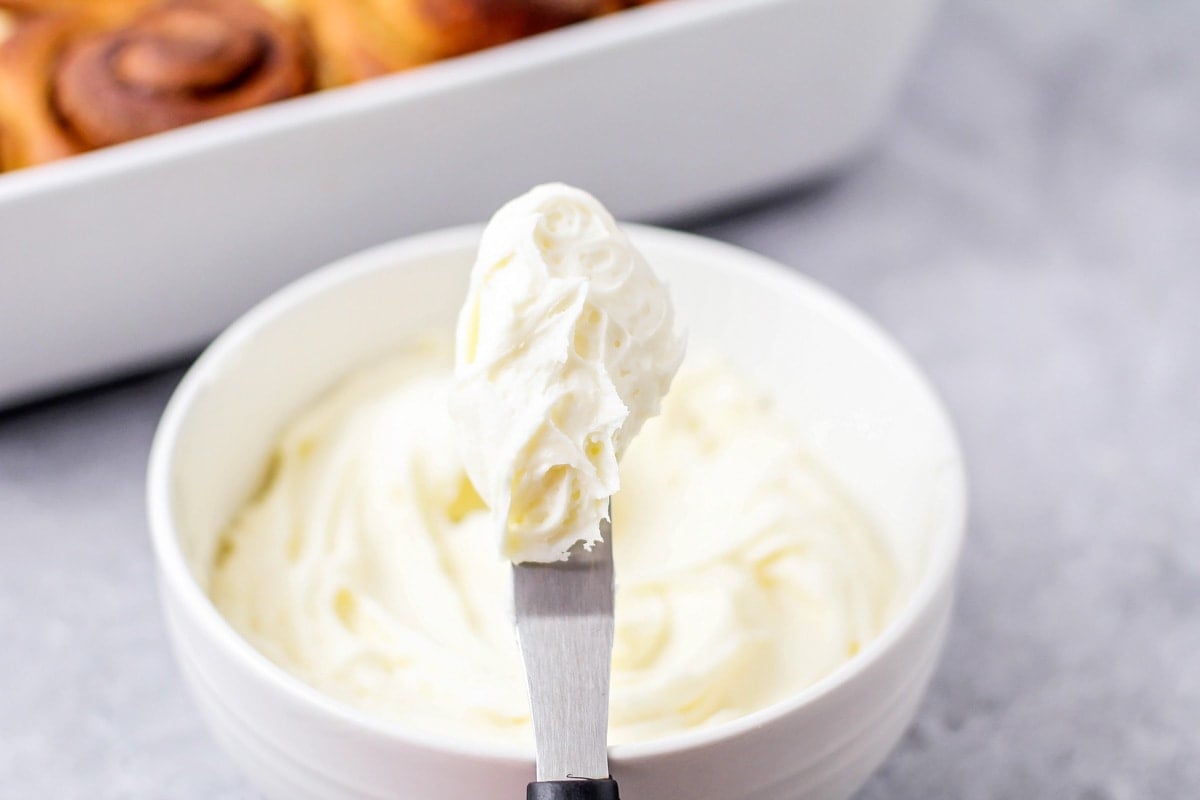 Cream cheese frosting in a white bowl.